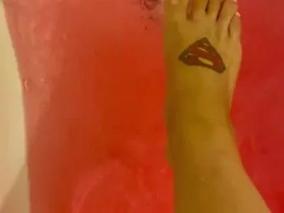 Feet in a bath with pink salt by Eva-Redford