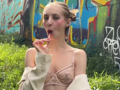 Sucking a lollipop outdoors by lili-fate